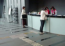 A tactile guide path in a museum in front of the information desk