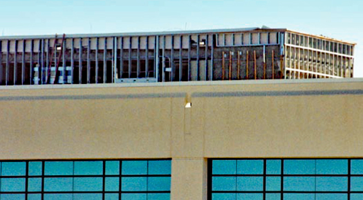 Photo showing the loss of EIFS at an elevator penthouse